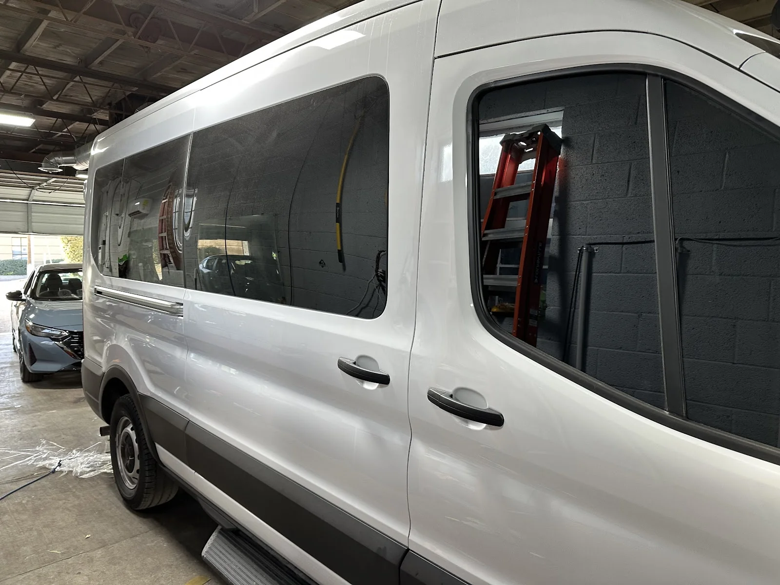 Inside Next Level Tint — shop interior and work bay